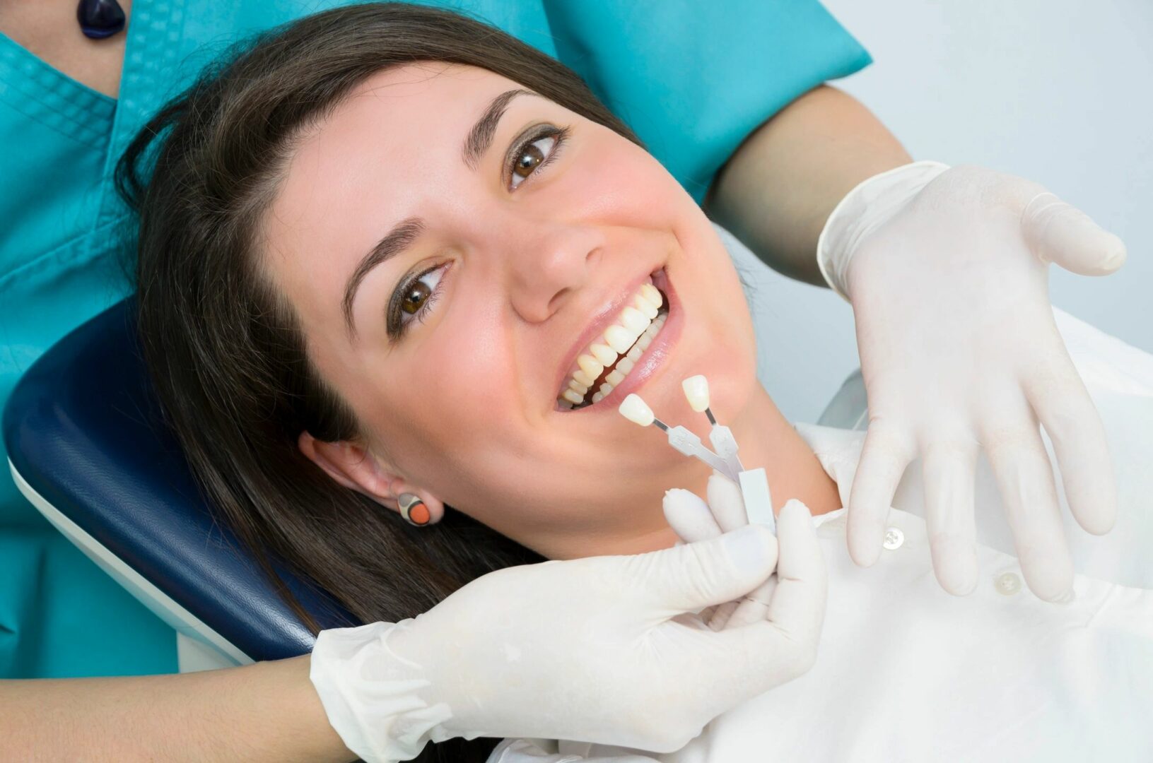 A dental patient being presented prosthetic teeth