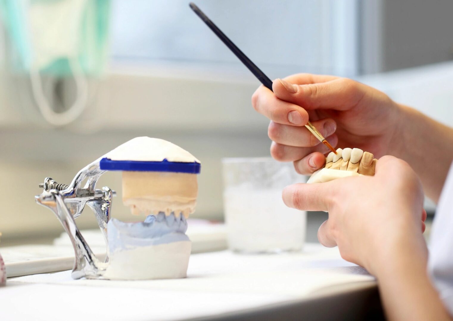 A person making dental dentures